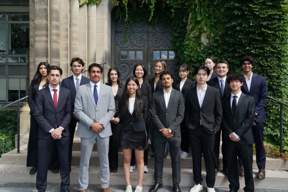 The 2026-27 RCVC team on the steps outside an ivy-covered campus building
